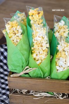 three bags filled with popcorn sitting on top of a table