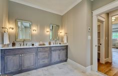 a large bathroom with two sinks and mirrors