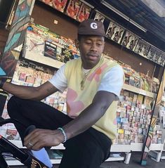 a man sitting on top of a bike in front of a store