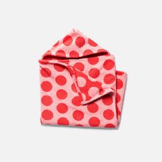 a pink and red polka dot towel folded on top of each other