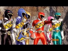 five power rangers standing in front of a mountain