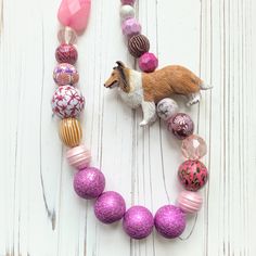 "Bright and bold long statement necklace for Collie dog lovers. Dramatic oversized beads in vibrant magenta and pink tones, along with hand-decoupaged wood beads in vintage prints is sure to be a conversation starter Necklace measures 36.5\"L. Handmade in the USA." Luxury Statement Beaded Necklace With Colorful Beads, Pink Necklace With Colorful Beads As Fashion Accessory, Pink Long Necklace With Large Beads, Pink Wooden Beaded Necklaces For Gifts, Luxury Statement Necklace With Colorful Beads, Long Pink Necklace With Large Beads, Pink Large Beaded Long Necklace, Playful Pink Jewelry With Large Beads, Pink Wooden Beads Necklace For Gift