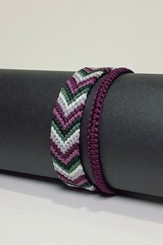 two bracelets sitting on top of a yoga mat