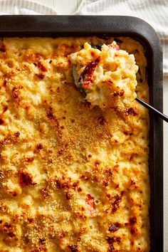 a casserole dish in a pan with a spoon resting on the side, ready to be eaten