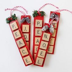 three wooden scrabbles with christmas decorations on them