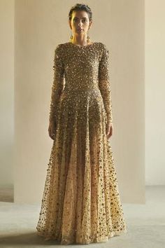 Gold flared gown with sequin embellishments and ombre effect.
Components: 1
Fabric: Tulle
Neckline: Round
Sleeve Length: Full
Color: Gold
Embellished
Bead and sequin embellishment
Flared silhouette - Aza Fashions Gold Gowns, Golden Gown, Gold Tulle, Gown Gold, Maxi Dress Designs, Ruffle Gown, Gold Gown, Embellished Gown, Maxi Gown