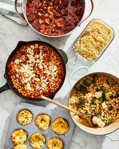 several pans filled with food on top of a white marble counter next to muffin tins