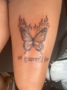 a woman's leg with a butterfly tattoo on it