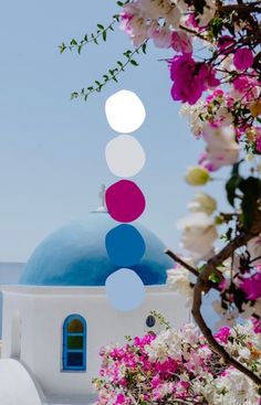 a blue dome with white and pink flowers around it