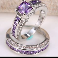 two wedding rings with purple and white stones on top of each other, one has a princess cut diamond in the center