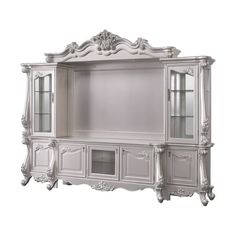 an ornate white entertainment center with glass doors