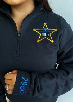 "This cute design is perfect for any sheriff wife and makes a perfect staple for your own wardrobe.  All of our items are made on high quality products, not lower end pieces. We offer the design shown in the main listing photo on unisex quarter zip sweatshirts and four different types of full-zip jackets available in ladies cut and unisex sizing.  See below for comments on sizing.  To see all of our police designs click here: https://www.etsy.com/shop/DoubleStitchDesigns1?ref=seller-platform-mcn Ladies Cut, Jacket With Pockets, Mens Cuts, Quarter Zip Sweatshirt, Star Shirt, Cute Design, Oversized Sweatshirt, Comfy Fits, Zip Sweatshirt