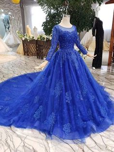 Cathedral Train Royal Blue Princess Ball Gown with Sleeves - DollyGown Blue Tulle Ball Gown For Wedding, Blue Tulle Floor-length Ball Gown, Blue Lace Dress With Illusion Neckline, Blue Long Sleeve Ball Gown For Banquet, Party Ball Gown With Sheer Bodice In Blue, Party Blue Ball Gown With Sheer Bodice, Blue Lace Ball Gown For Wedding, Blue Lace Evening Dress With Illusion Neckline, Blue Tulle Gown For Debutante Ball