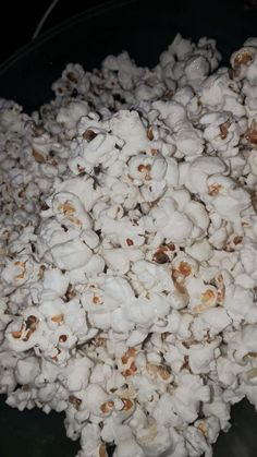 a bowl full of popcorn sitting on top of a table