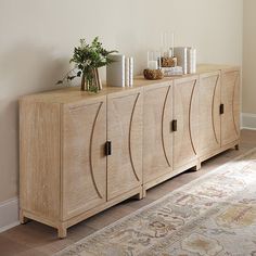 a sideboard with candles and flowers on top