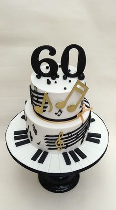 a cake decorated with musical notes, music keys and the number 60 on top of it