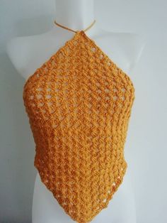 an orange crocheted halter top on a mannequin