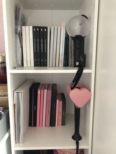 a bookshelf filled with lots of books and a lamp