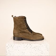 The Asti, our classic combat boots, are perfect for long city days. Soft, luxurious leather and gold detailing lend an elegant feel to a utilitarian style; cotton laces allow for adjustability, while a size zipper makes slipping them on a breeze. With their close fit and sleek shape, the Asti will take you from work to date night and everything in between. The Asti Olive is a neutral army green. Product Details: Made with premium Italian calf leather or suede Leather lining Lightly padded leathe Elegant Boots, Utilitarian Style, Thick Socks, Beautiful Boots, How To Make Shoes, Green Suede, Cotton Lace, Gold Details, Pebbled Leather