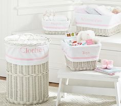 three wicker baskets with personalized labels on them sitting on a bench in front of a window