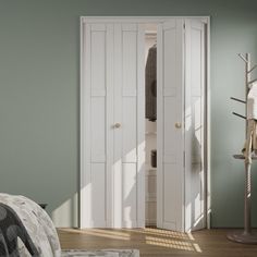 a bedroom with green walls and white closets next to a bed in the corner