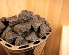 a bucket filled with rocks sitting on top of a wooden floor