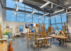 an art studio with lots of easels and paintings