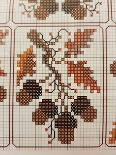 the cross stitch pattern has been made with different colors and shapes, including oranges and browns