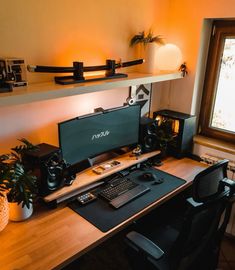 a desk with a computer and speakers on it