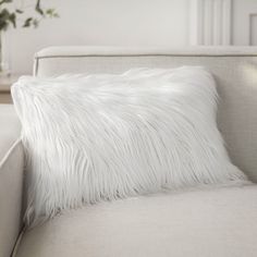 a white pillow sitting on top of a couch