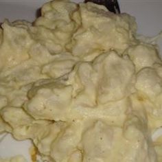 mashed potatoes on a white plate with a fork