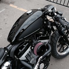 the front end of a black motorcycle parked in a parking lot