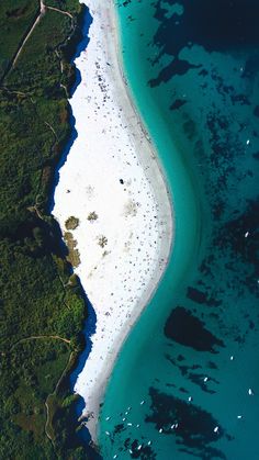 an aerial view of the white sand beach and ocean with apple logo on it, as seen from above