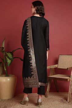 Grab this beautiful 3-piece set. The set comes with ethnic motif printed straight shape kurta has v neck, 3/4th sleeves & calf length teamed with solid trouser pant with side pocket and a dupatta. Color - Black Kurta Fabric-Silk Blend Pant Fabric-Silk Blend Dupatta Fabric - Silk Blend Neck-V Neck Sleeves-3/4th Sleeves Work -Ethnic Motif Print Detailing Washing Instructions-Dry Clean DISCLAIMER - The color of the product may be differ due to screen settings of device. A misprint here and a color Diwali Lawn Suit With Embroidered Border, Black Chanderi Churidar With Embroidered Border, Chanderi Churidar With Embroidered Border In Black, Elegant Sets With Printed Motifs For Navratri, Straight Kurta Salwar Kameez With Traditional Patterns For Navratri, Unstitched Sets With Traditional Patterns For Navratri, Traditional Straight Kurta Churidar With Traditional Patterns, Traditional Straight Kurta Churidar With Patterns, Traditional Straight Kurta Churidar