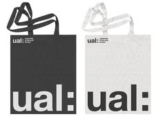 two shopping bags with the word ual on them, one is black and white