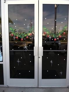 two glass doors with christmas decorations on them