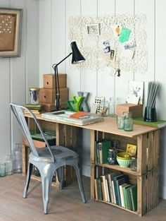 a desk with a chair, lamp and bookshelf in front of the wall