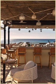 Beachfront bar with bamboo canopy and hanging lamps, sea in the backdrop. Nobu Hotel Los Cabos, Float Bar, Luxury Hotels, Infinity Pool