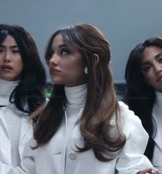 three women in white coats standing next to each other with their hands on their hips