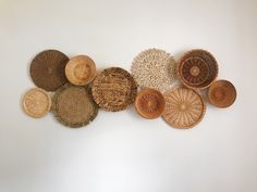 several woven baskets are arranged on the wall