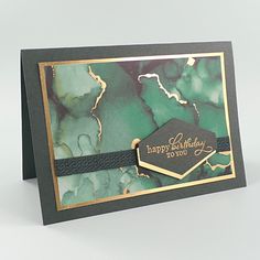 a green and gold birthday card with a black ribbon around the edge that says happy birthday to you