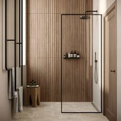 a walk in shower sitting inside of a bathroom next to a wooden wall and floor