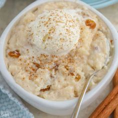 a white bowl filled with mashed potatoes and topped with whipped cream