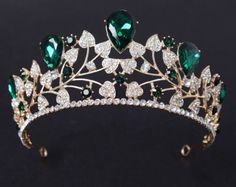 a tiara with green and white stones on it