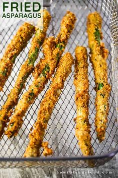 fried asparagus in a wire basket with text overlay that reads fried asparagus