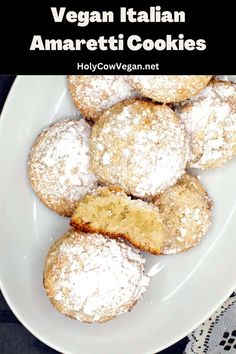 vegan italian amarettii cookies on a white plate with powdered sugar in the middle