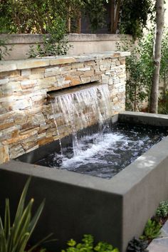 an outdoor fountain with water flowing from it