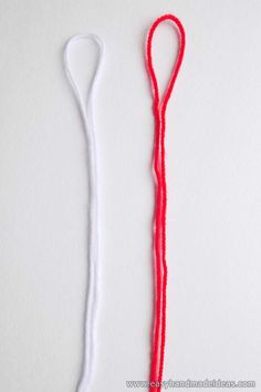 a red string is next to a white thread