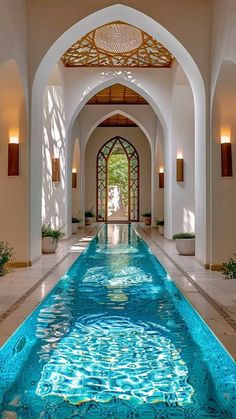 an indoor swimming pool in the middle of a building with arches and arched doorways