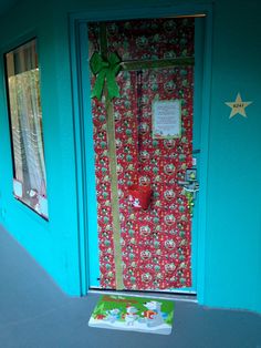 the door is decorated with red and green wrapping